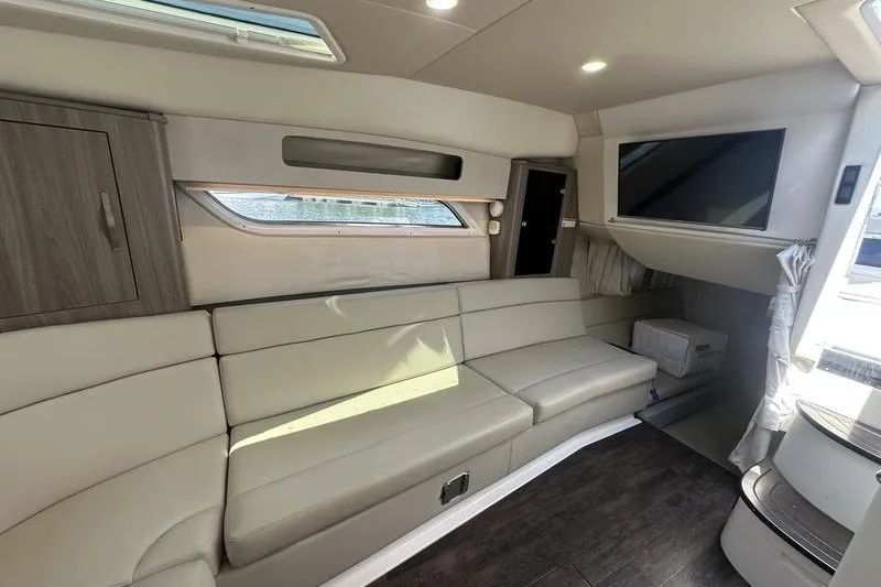 Slide: The Image of Interior of 2019 Regal 35 Sport Coupe with beige seating and modern amenities. - 10