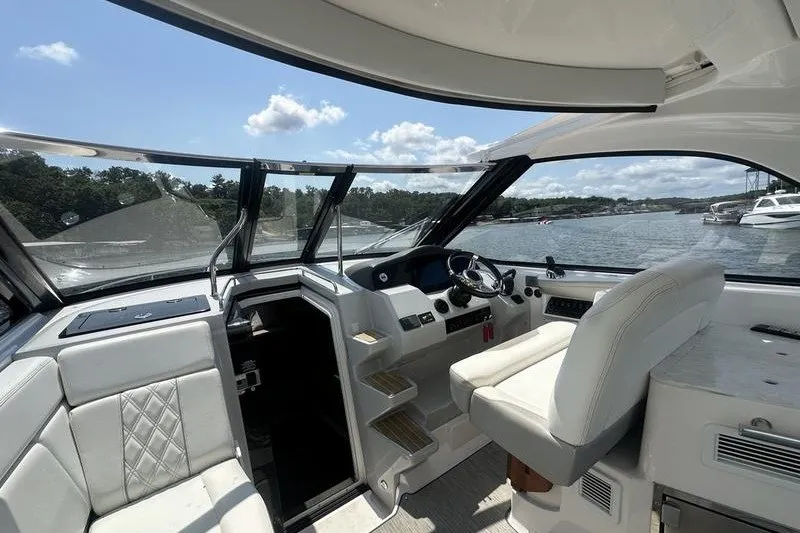 Slide: The Image of Interior of a 2019 Regal 35 Sport Coupe yacht with luxurious seating and helm. - 14