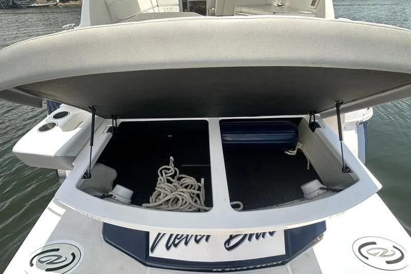 Slide: The Image of 2019 Regal 35 Sport Coupe boat storage compartment with ropes and fender. - 17