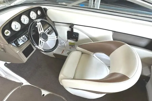 Slide: The Image of Interior of a 2007 Four Winns 200 Horizon boat, featuring steering wheel and gauges. - 9
