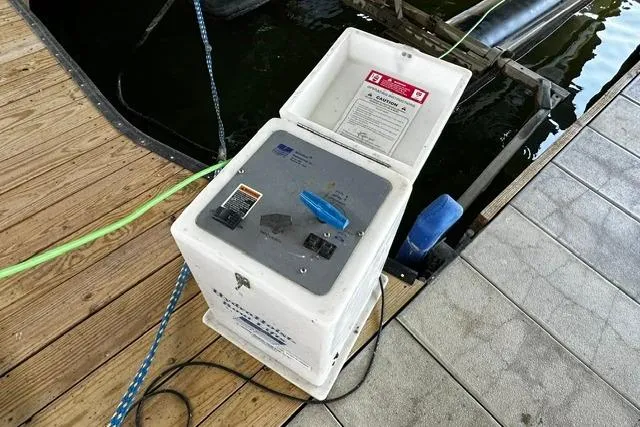 Slide: The Image of Power pedestal on dock near water, connected to a Four Winns 200 Horizon boat. - 23
