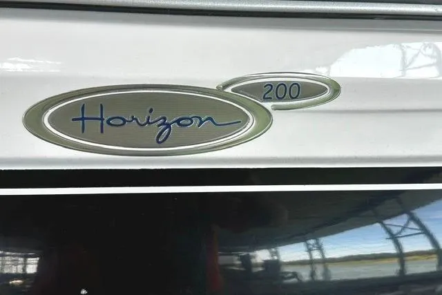 Slide: The Image of 2007 Four Winns 200 Horizon boat emblem with sleek design and reflective surface. - 4