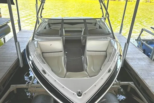 Slide: The Image of 2007 Four Winns 200 Horizon boat docked on a serene lake. - 6