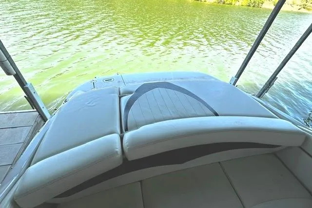 Slide: The Image of 2007 Four Winns 200 Horizon boat on a calm lake, featuring a cushioned deck. - 8