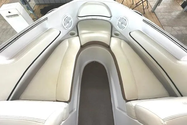 Slide: The Image of 2007 Four Winns 200 Horizon boat interior with white cushioned seating and built-in speakers. - 12