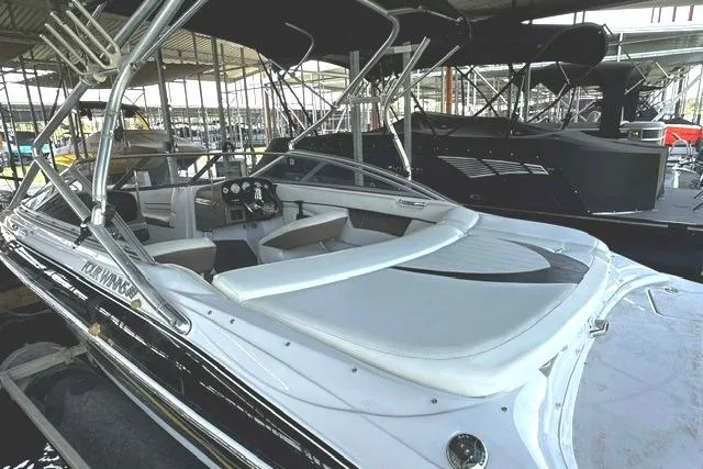 Slide: The Image of 2007 Four Winns 200 Horizon boat docked in a marina, featuring sleek design and spacious seating. - 5
