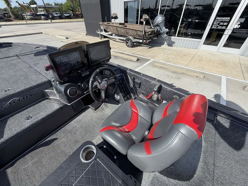 Slide: The Image of The image shows the cockpit of a 2018 Falcon F205 boat with a modern helm. - 18