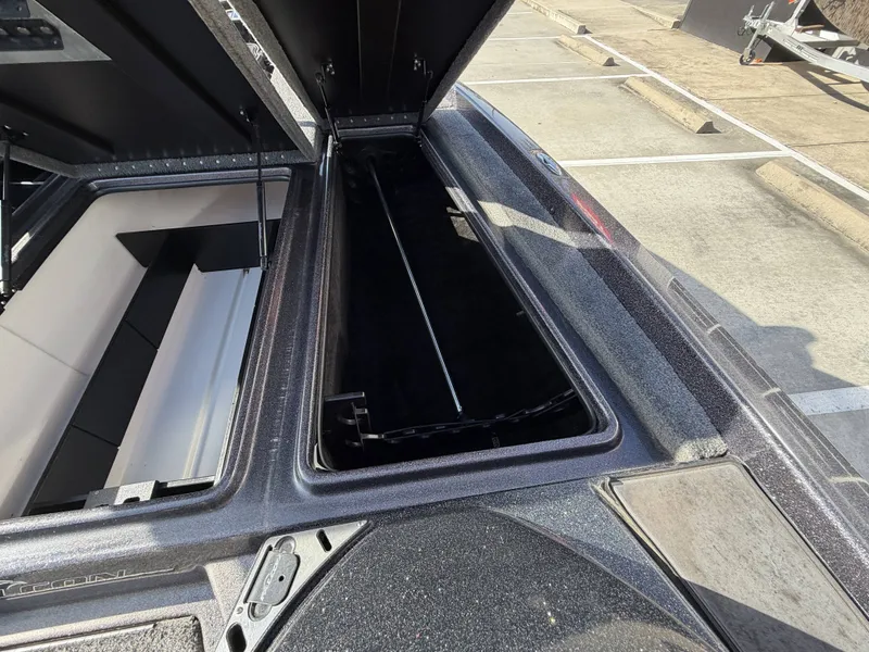 Slide: The Image of An open storage compartment on a 2018 Falcon F205 boat, parked in a lot. - 28