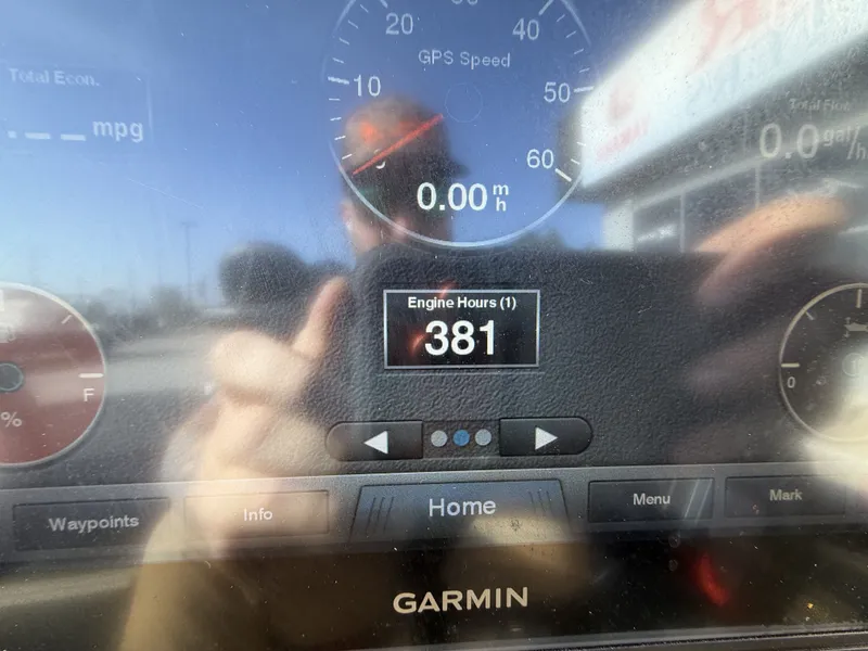 Slide: The Image of A Garmin screen displays 381 engine hours. Reflections are visible. - 21