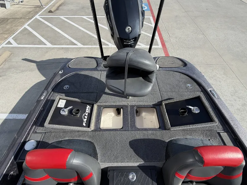 Slide: The Image of The image shows the cockpit of a 2018 Falcon F205 boat with two seats and storage compartments. - 15