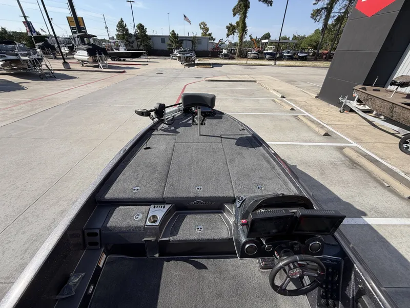 Slide: The Image of The image shows the deck of a 2018 Falcon F205 boat with a steering console and seats. - 22