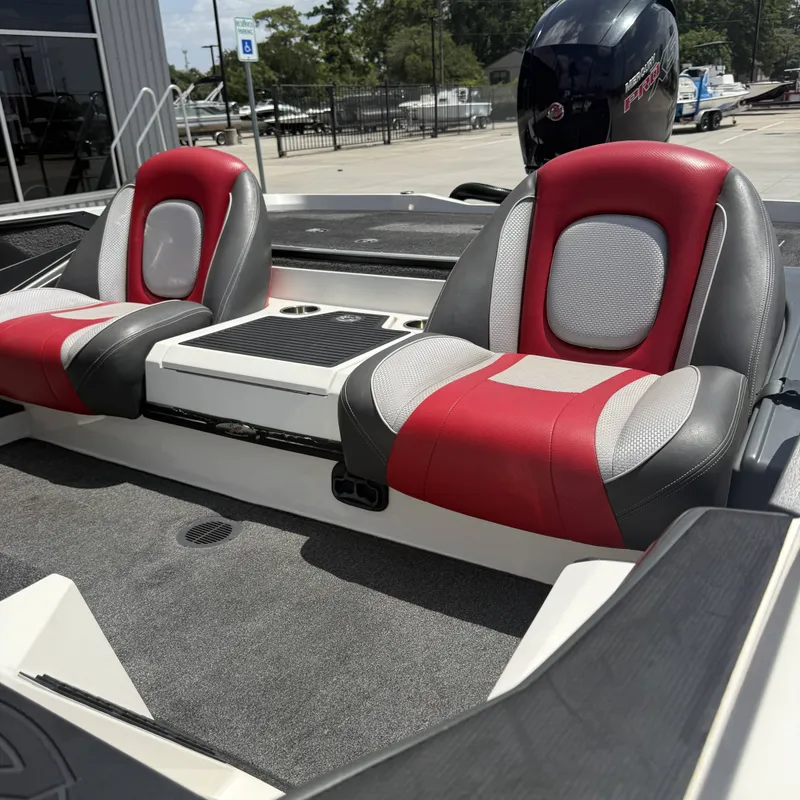 Slide: The Image of The image shows the interior of a 2019 Ranger Z518 boat with red and gray seats. - 11