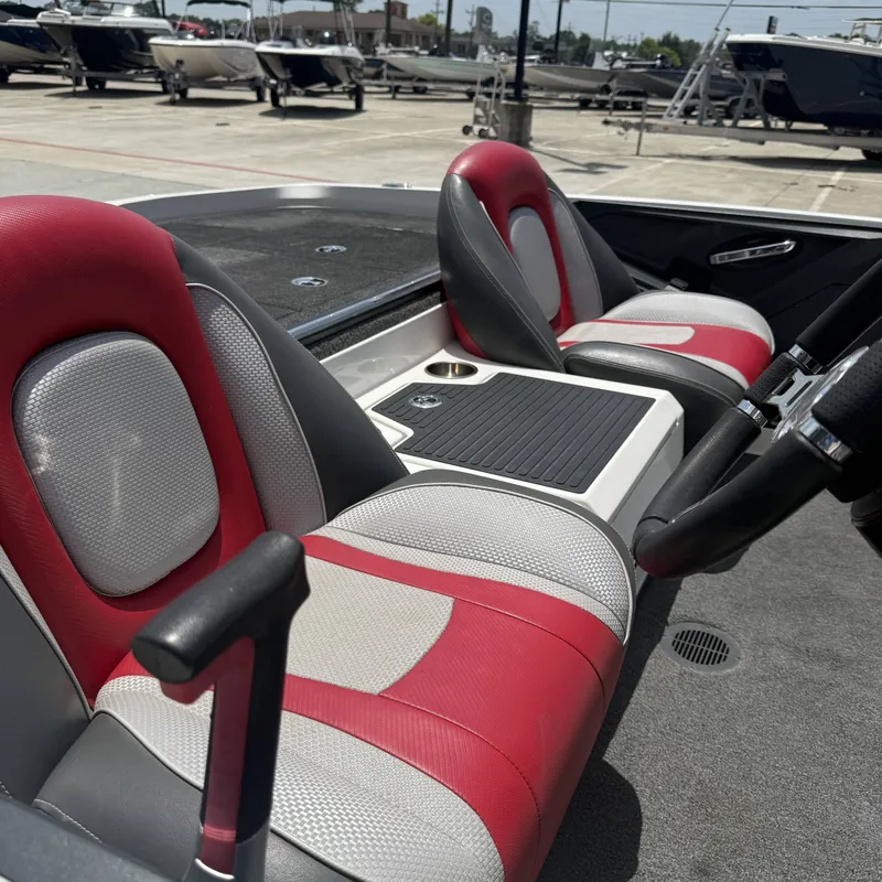 Slide: The Image of The image shows the interior of a 2019 Ranger Z518 boat with red and gray seats. - 15