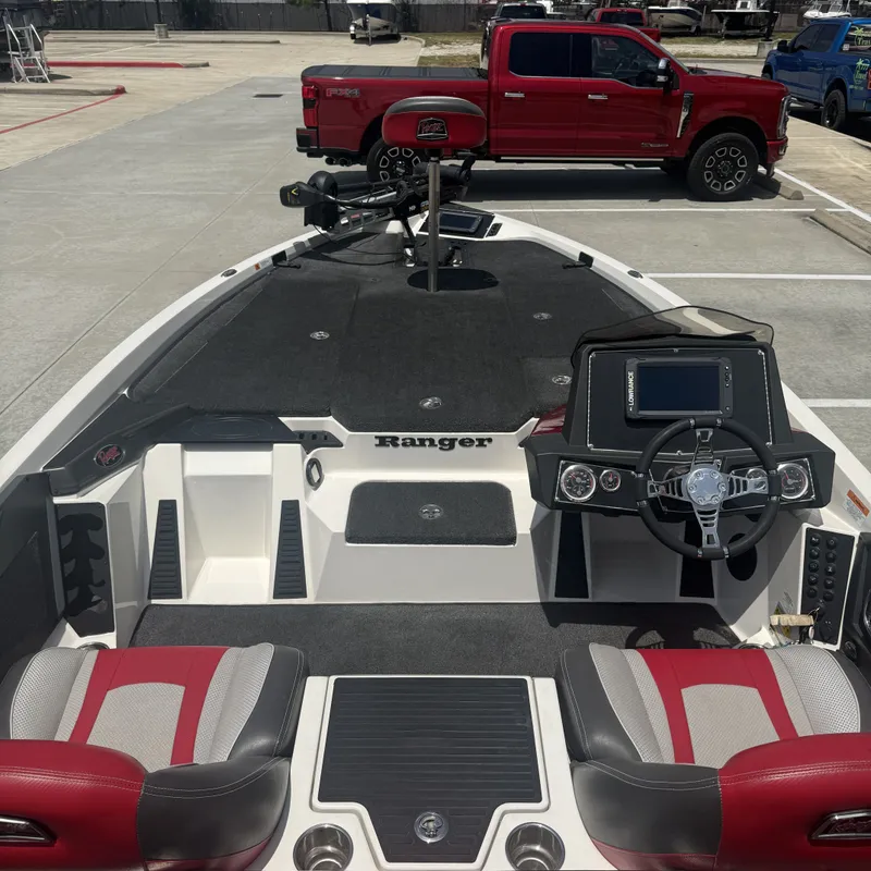 Slide: The Image of The image shows the cockpit of a 2019 Ranger Z518 boat with red and gray seats. - 12