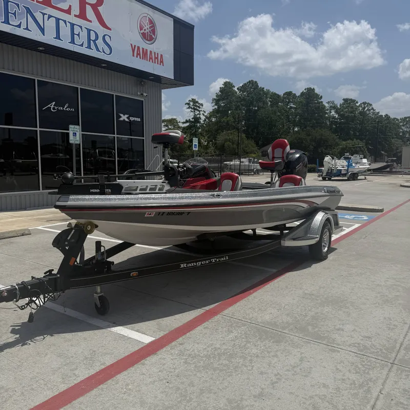 Slide: The Image of A 2019 Ranger Z518 boat on a trailer outside a store with a Yamaha logo. - 3