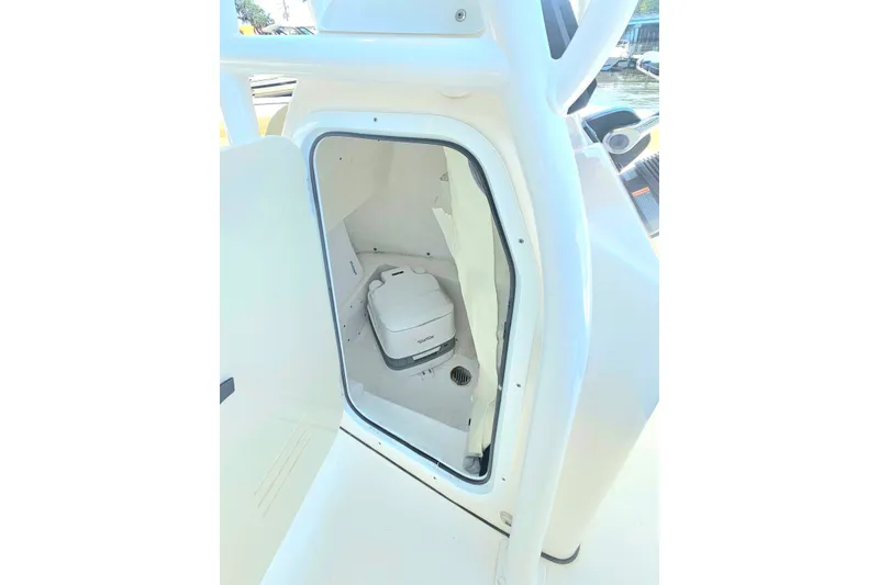 Slide: The Image of 2019 Tidewater 210 LXF boat interior with compact marine toilet. - 21