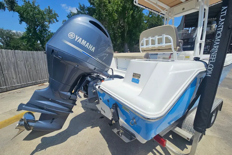 Slide: The Image of 2019 Tidewater 210 LXF boat with Yamaha outboard motor, parked outdoors. - 5
