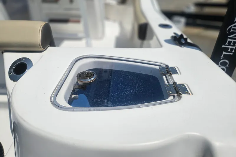Slide: The Image of 2019 Tidewater 210 LXF boat detail showing a hinged compartment with a transparent lid. - 7