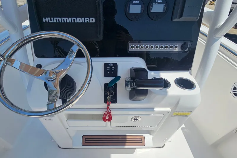 Slide: The Image of 2019 Tidewater 210 LXF boat console with steering wheel and control panel. - 19