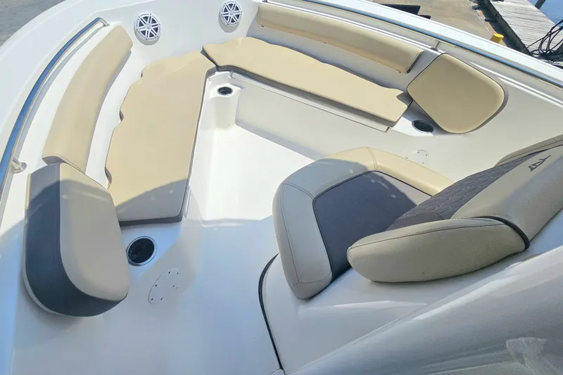Slide: The Image of 2019 Tidewater 210 LXF boat interior with beige seating and cup holders. - 12