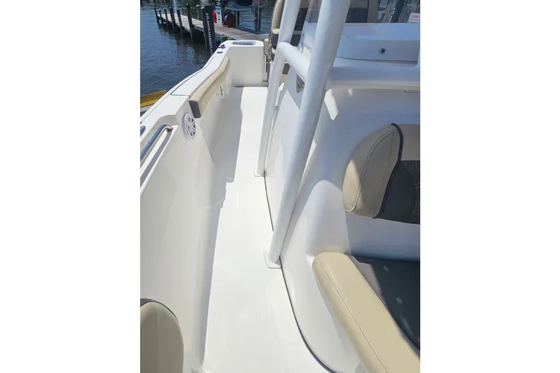 Slide: The Image of 2019 Tidewater 210 LXF boat interior with beige seating and white deck. - 23