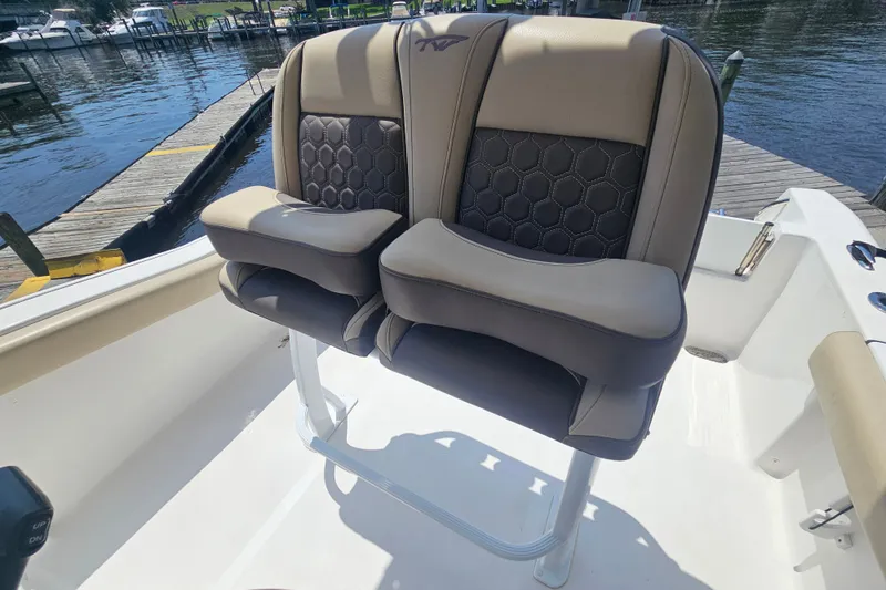 Slide: The Image of Dual captain's chairs on 2019 Tidewater 210 LXF boat, dockside view. - 13