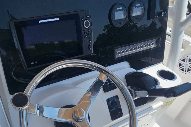 Slide: The Image of 2019 Tidewater 210 LXF boat dashboard with steering wheel and Humminbird Helix 9 display. - 20
