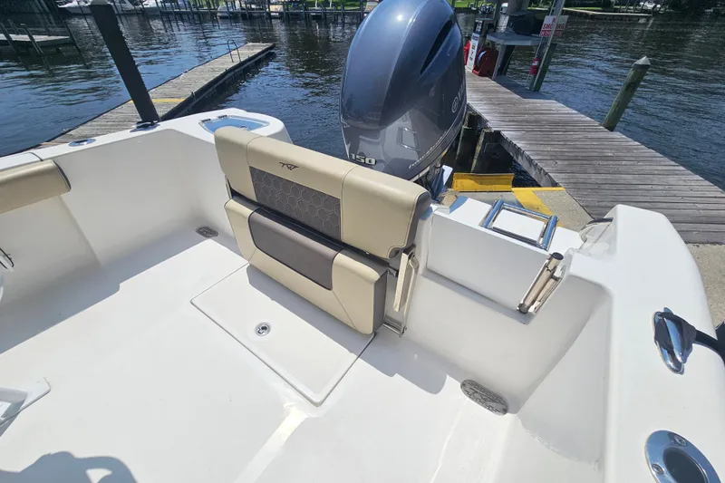 Slide: The Image of 2019 Tidewater 210 LXF boat with Yamaha 150 engine, docked by a wooden pier. - 15