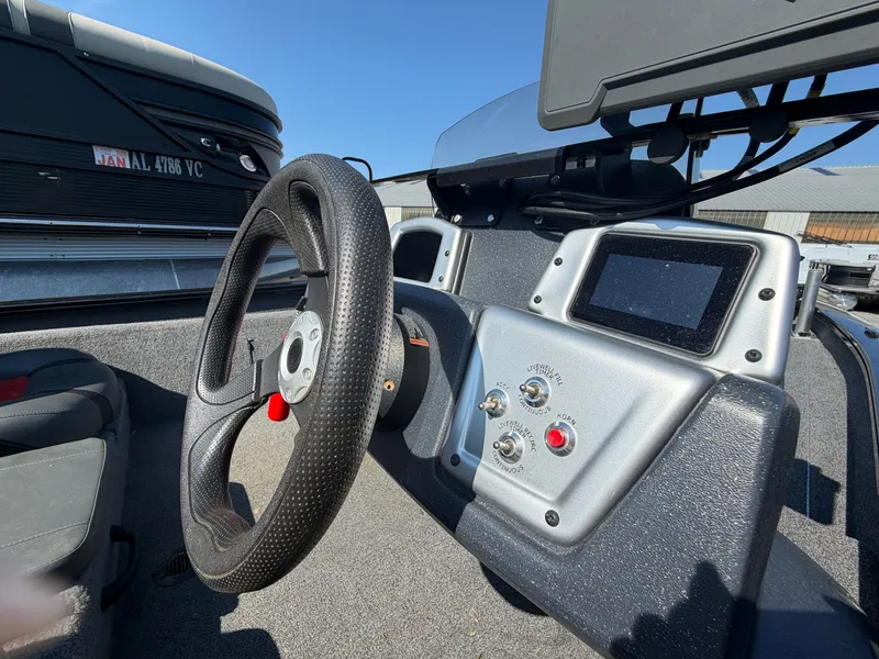 Slide: The Image of The image shows the cockpit of a 2025 Tracker Pro Team 190 boat with a steering wheel and instruments. - 17