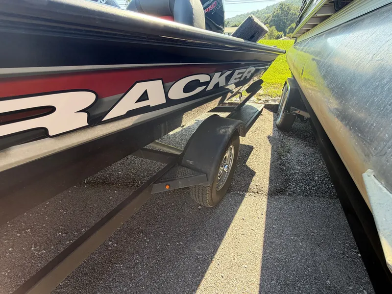Slide: The Image of A 2025 Tracker Pro Team 190 boat on a trailer, parked next to another boat. - 21