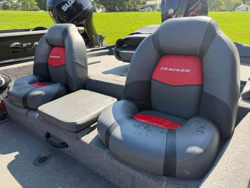 Slide: The Image of Two cushioned seats in a Tracker Pro Team 190 boat, with a Suzuki outboard motor in the background. - 15