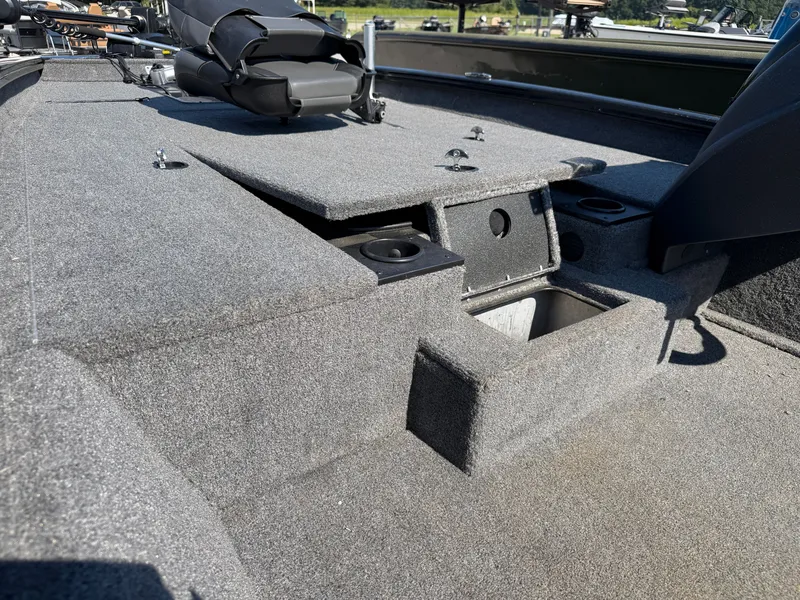 Slide: The Image of The image shows the deck of a 2025 Tracker Pro Team 190 boat with gray carpeting. - 16