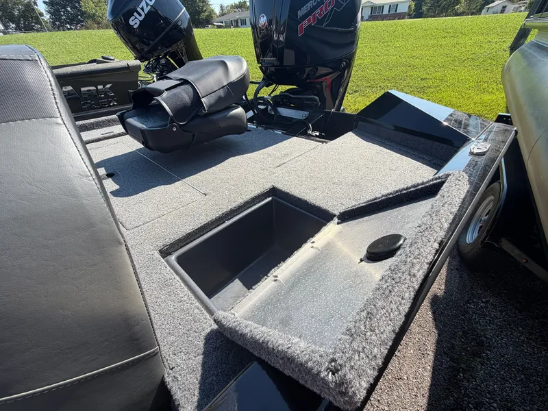 Slide: The Image of The image shows the deck of a 2025 Tracker Pro Team 190 boat with an open storage compartment. - 20
