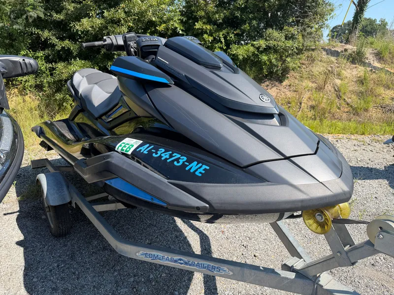 Slide: The Image of A 2020 Yamaha FX Cruise Super Charger on a trailer, surrounded by trees. - 2