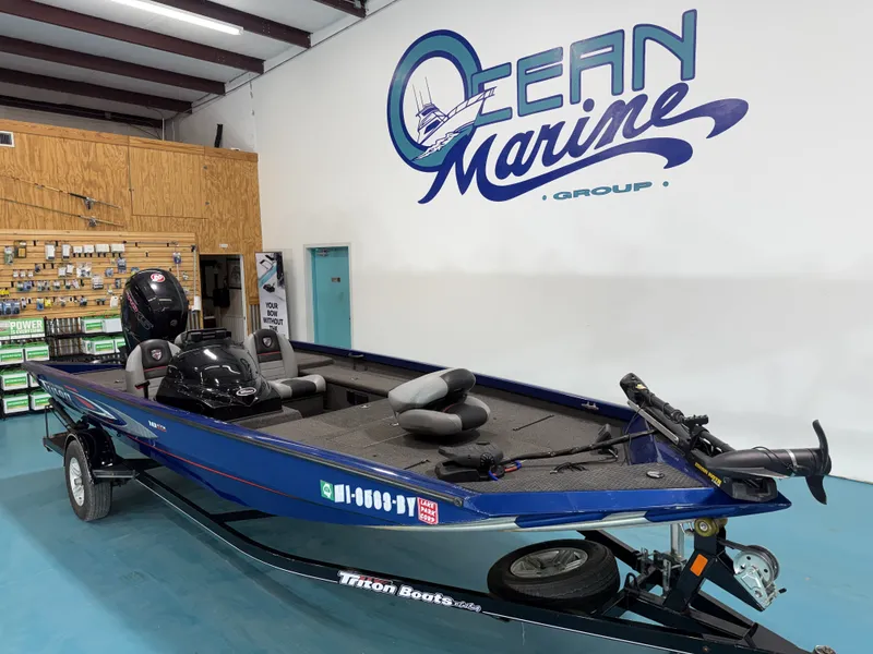 Slide: The Image of A blue 2017 Triton 18CTX is in a showroom. "Ocean Marine Group" is on the wall. - 5