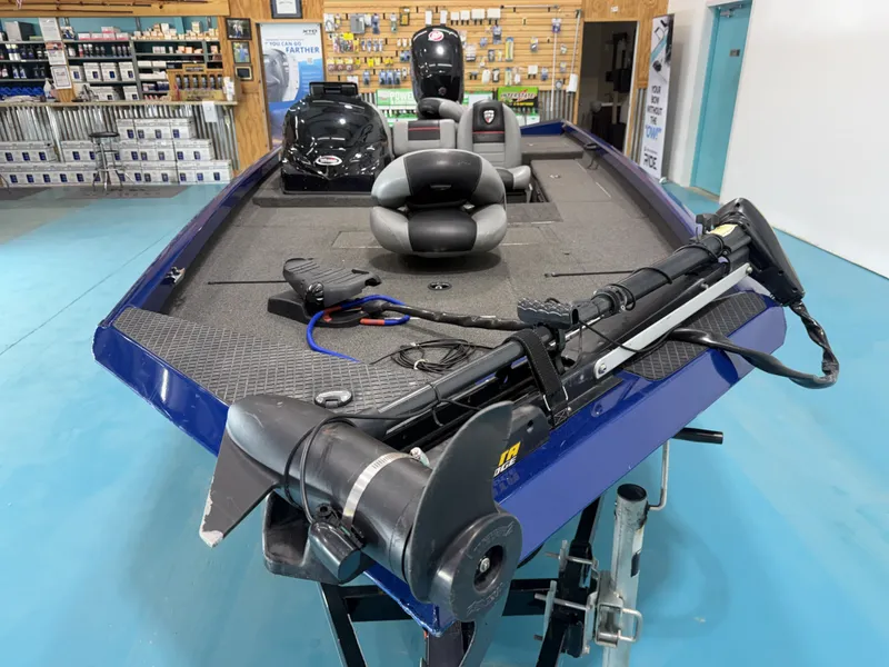 Slide: The Image of A 2017 Triton 18CTX boat in a showroom. It features a blue hull and spacious deck. - 6