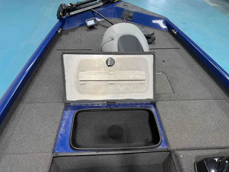 Slide: The Image of The image shows the deck of a 2017 Triton 18CTX boat with storage and seating. - 15
