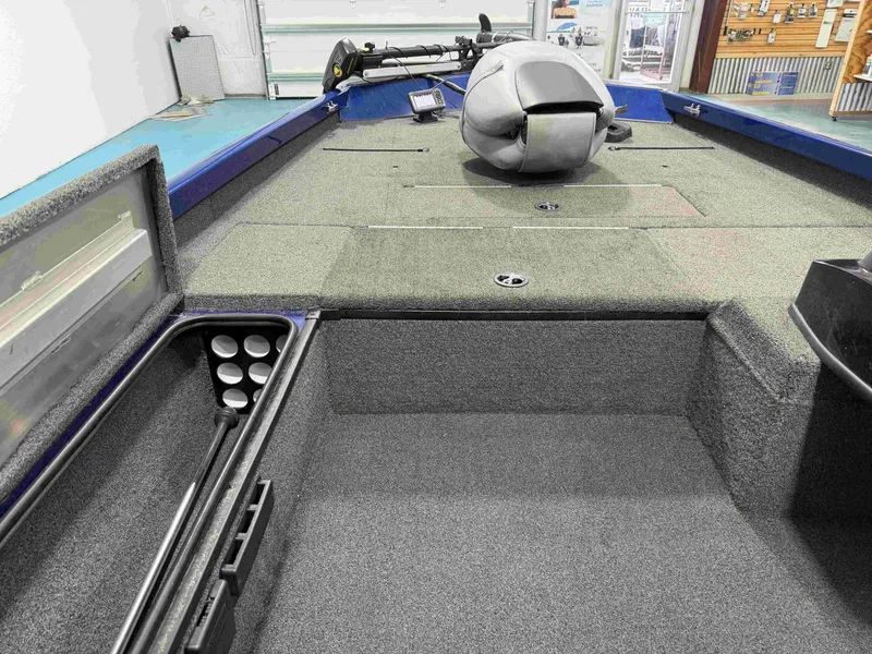 Slide: The Image of The image shows the deck of a 2017 Triton 18CTX boat with gray carpeting. - 13