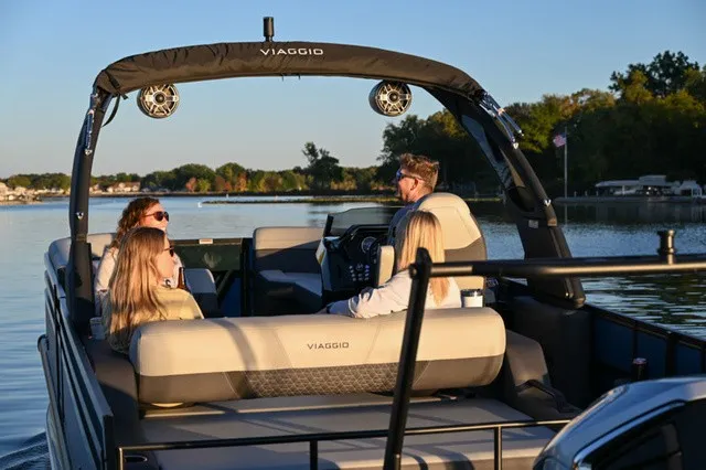 The Image of Four people relax on a Viaggio Z22S boat on a calm lake. - 1