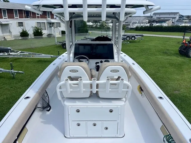 Slide: The Image of The image shows the cockpit of a 2020 Sportsman Masters 267 Bay Boat with two seats and a helm. - 16