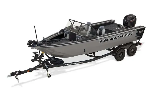 The Image of A gray Tracker Targa V-18 Combo boat on a trailer, featuring an outboard motor and two seats. - 1