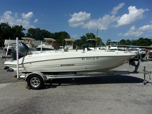 Slide: The Image of A white 2017 Stingray 182 SC boat is on a trailer in a parking lot. - 3