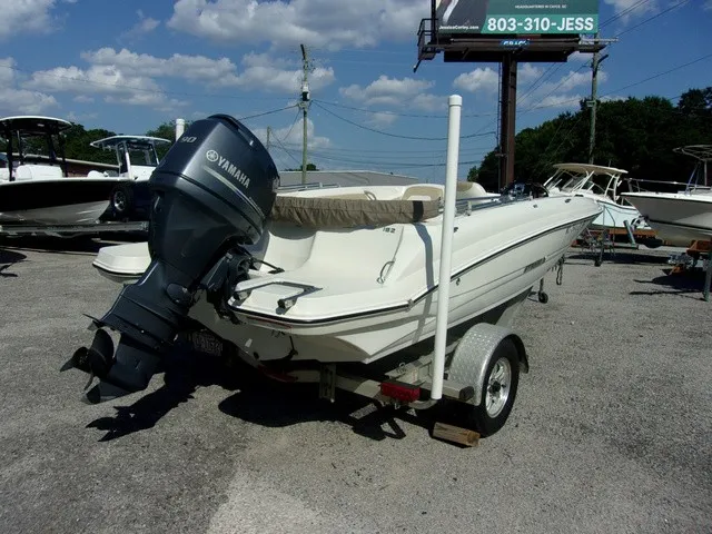 Slide: The Image of A white 2017 Stingray 182 SC boat on a trailer with a Yamaha outboard motor. - 4