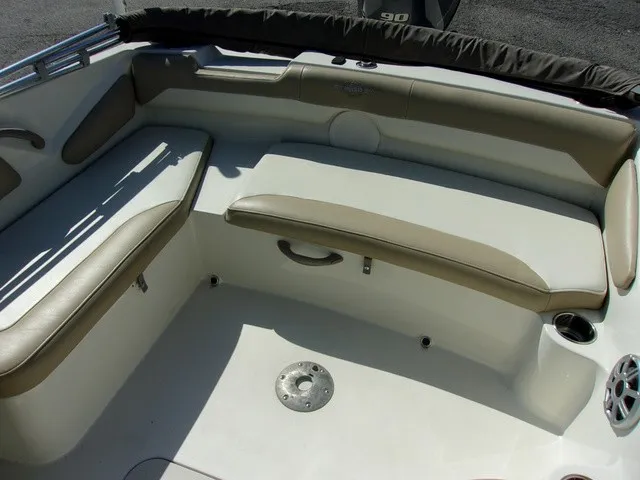 Slide: The Image of The image shows the seating area of a 2017 Stingray 182 SC boat with beige upholstery. - 7