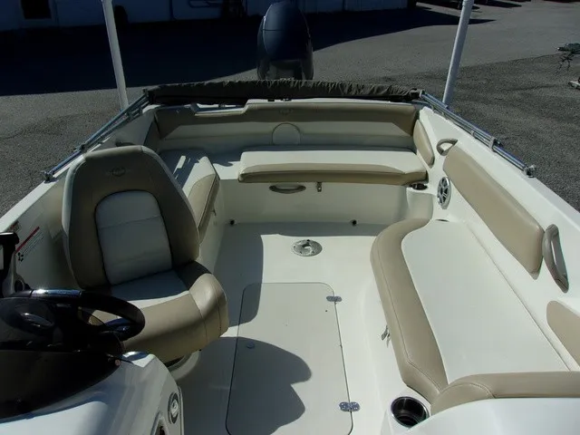 Slide: The Image of The image shows the cockpit of a 2017 Stingray 182 SC boat with beige seating. - 9