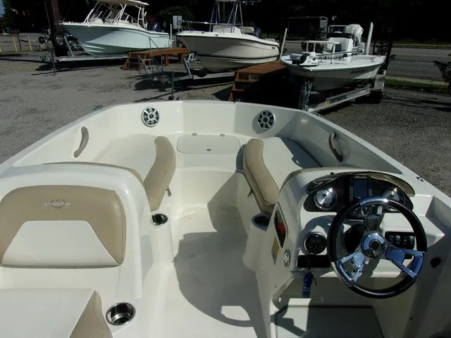 Slide: The Image of The image shows the cockpit of a 2017 Stingray 182 SC boat with beige seats and a helm. - 10