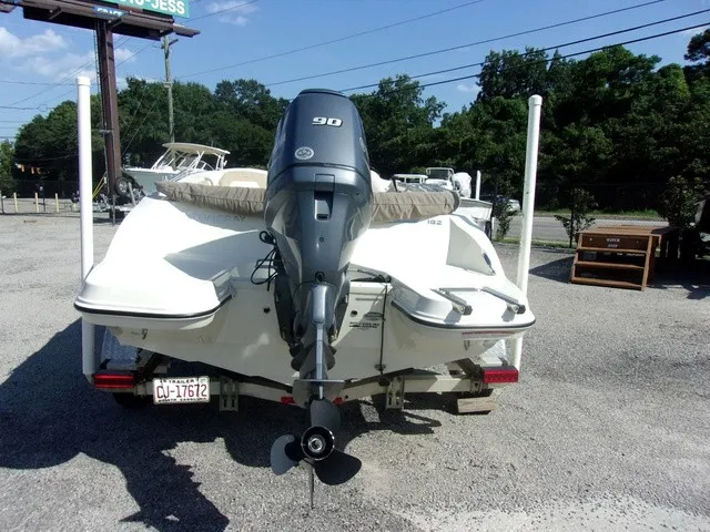 Slide: The Image of A 2017 Stingray 182 SC boat with a 90 HP outboard motor, parked on a trailer. - 5