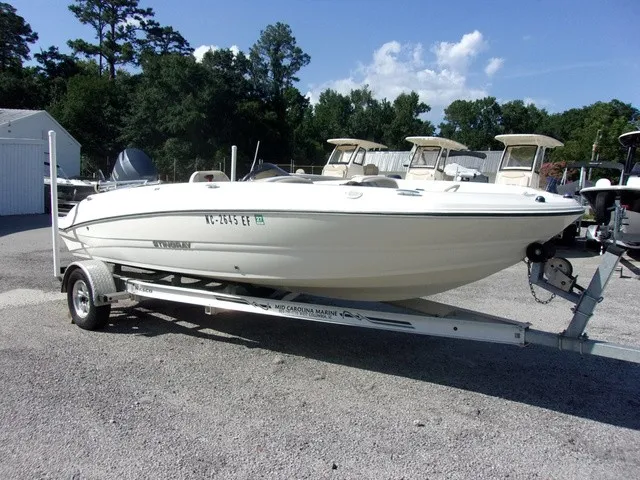 Slide: The Image of A white 2017 Stingray 182 SC boat is on a trailer in a gravel lot. - 2