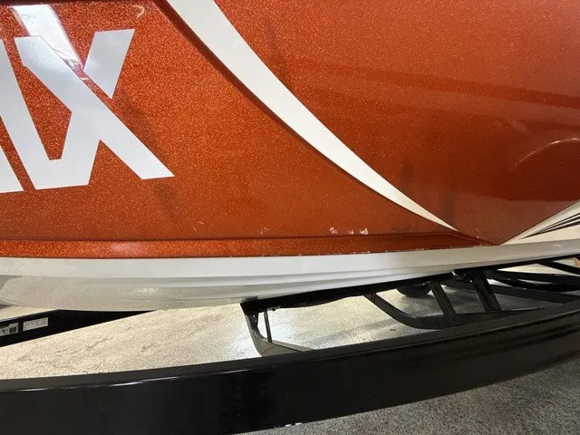 Slide: The Image of Close-up of the orange hull of a Tigé Z3 boat on a trailer. - 32