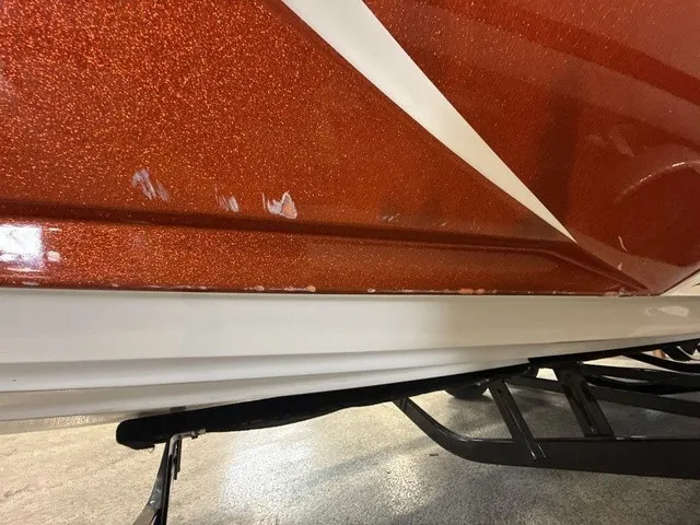 Slide: The Image of Close-up of the orange hull of a 2017 Tigé Z3 boat on a trailer. - 33